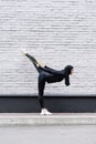 Flexible muslim sportswoman in hijab exercising