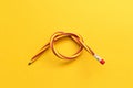 Flexible pencil . Isolated on yellow background