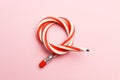 Flexible pencil on a pink background. Bent pencils two-color Royalty Free Stock Photo