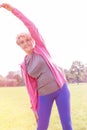 Flexible active senior woman doing workout in park