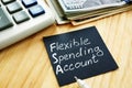 Flexible spending account FSA sign on a black piece of paper