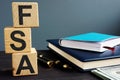 Flexible spending account FSA written on a wooden cubes Royalty Free Stock Photo