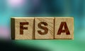 Flexible spending account FSA written on a wooden cubes. Financial concept Royalty Free Stock Photo