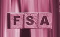 Flexible spending account FSA written on a wooden cubes. Financial concept
