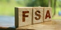 Flexible spending account FSA written on a wooden cubes. Financial concept Royalty Free Stock Photo