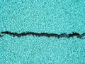 Flexible turquoise tile for playground with a crack in the middle. Tiles made from a mixture of rubber crumb. Royalty Free Stock Photo