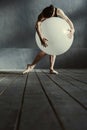 Flexible woman dancing using the white balloon