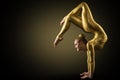 Flexible Woman Gymnast doing Yoga Stretching Pose. Standing on hands Back bending. Gold perfect strong healthy Acrobat Body Royalty Free Stock Photo