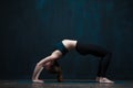 Flexible woman practicing advanced yoga asana Royalty Free Stock Photo