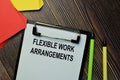 Flexible Work Arrangements write on a paperwork isolated on wooden background Royalty Free Stock Photo