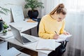 Flexible working, flexible work. Young woman freelancer working at home office with laptop and documents. Flexible work Royalty Free Stock Photo