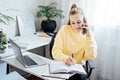 Flexible working, flexible work. Young woman freelancer working at home office with laptop and documents. Flexible work Royalty Free Stock Photo