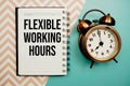 Flexible Working Hours text written on notepad with alarm clock Royalty Free Stock Photo