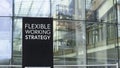 Flexible Working Strategy sign in front of a modern office building