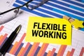 FLEXIBLE WORKING text in the office notebook with office tools, business