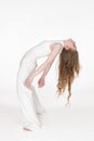 Flexible young blonde woman dancer with eyes closed bending over backwards. Full length, side view Royalty Free Stock Photo