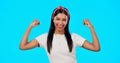 Flexing, empowerment and woman showing arm muscle, strong and happy person isolated in a studio blue background. Bicep Royalty Free Stock Photo