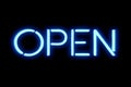 Flickering blinking blue neon sign on black background, open shop bar sign Royalty Free Stock Photo