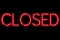 Flickering blinking red neon sign on black background, closed restaurant shop bar sign