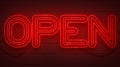 Flickering blinking red neon sign on brick wall background, open shop bar sign Royalty Free Stock Photo