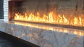 The flickering flames dance behind the glass doors of the fireplace while the marble surround reflects the light Royalty Free Stock Photo