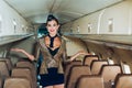 Flight attendant. Commercial airplane flying with beautiful charming stewardess. Attendant and airhostess. Beautiful air