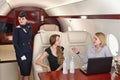 Flight attendant and passengers inside the plane Royalty Free Stock Photo