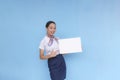 A flight attendant presenting a sign board to the passengers. Stewardess pointing at an empty white board on the side Royalty Free Stock Photo