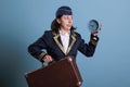 Flight attendant running late, holding alarm clock, carrying suitcase