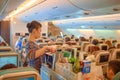 Flight attendant serve food and drinks Royalty Free Stock Photo