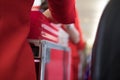 flight attendant serving food to passenger on aircraft. stewardess offer drink on board. hostess with trolley Royalty Free Stock Photo