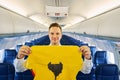 Flight attendant showing a lifejacket during the pre-flight safety demonstration