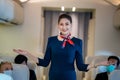 The flight attendant smiling, serving the passengers who were getting on the plane