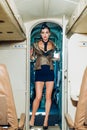 Flight attendant waiting for the passengers to board. Attendant. Portrait of smiling flight attendant serving in