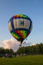 Flying balloon with passengers in a basket against the blue sky at the festival of Aeronautics summer evening in Pereslavl-Zalessk