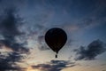 Flying balloon with passengers in a basket against the blue sky at the festival of Aeronautics summer evening in Pereslavl-Zalessk