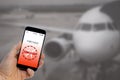 Flight canceled notification on Smartphone announces bad news to tourist