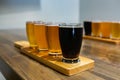 Flight craft beer glasses on wooden tray Royalty Free Stock Photo