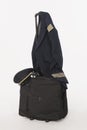 Flight crew uniform and hat hanging on trolley baggage on white background Royalty Free Stock Photo