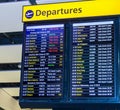 A flight departure board showing long-haul international flights leaving from London`s Heathrow airport. Royalty Free Stock Photo