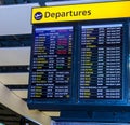 A flight departure board showing long-haul international flights leaving from London`s Heathrow airport. Royalty Free Stock Photo