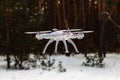 Flight of the drone in the winter forest. The concept of unmanned aerial vehicles. UAV, technology and observations