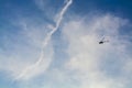The blue sky with white clouds in the warm summer. Flight of the helicopter highly over the head. Royalty Free Stock Photo