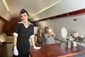 Flight hostess and passengers inside the plane Royalty Free Stock Photo