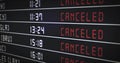 Flight information board with canceled flights. Arrival and departure times on information board are changed to canceled.