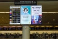 Flight information display service board in airport providing flight arrivals and departure times with covid messaging and Royalty Free Stock Photo