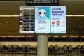 Flight information display service board in airport providing flight arrivals and departure times with covid messaging and Royalty Free Stock Photo