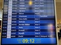 Flight information displayed on the blue colored led monitor display at the international airport. Tourists plan to travel during Royalty Free Stock Photo