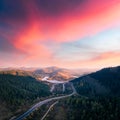 Flight over the autumn mountains with mountain road serpentine Royalty Free Stock Photo