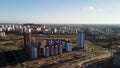 Flight over city blocks. Multi-storey buildings and construction site. Flying in the backlight of the setting sun. Aerial Royalty Free Stock Photo